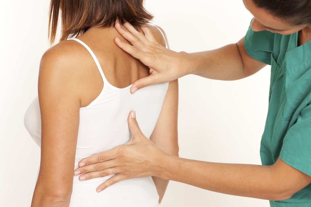 doctor examines the back with chest osteochondrosis